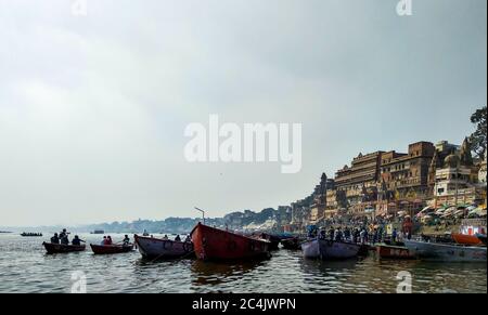 Dashashwamedh Ghat, Varanasi, Uttar Pradesh, India; 30-Jan-2019; rows of boats carrying passengers heading into the river Stock Photo