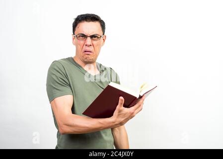 Man reading something that is surprising him a lot in a book. Mid shot. White background. Stock Photo