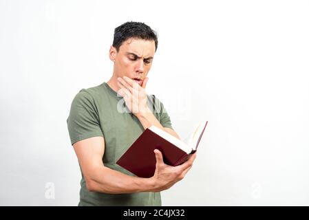 Man very concentrated on reading a book. Mid shot. White background. Stock Photo