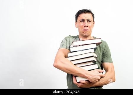 Very worried student holding a lot of books. Mid shot. White background. Stock Photo