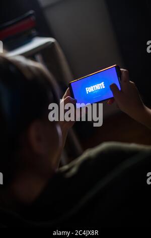 Bucarest, Romania - June 25. 20202: Image a child playing Fortnite, a game by Epic Games, on a mobile phone in Bucharest, Romania. Stock Photo