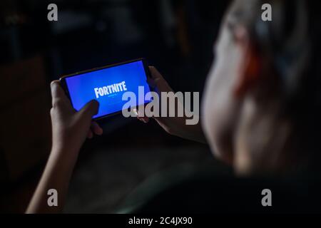 Bucarest, Romania - June 25. 20202: Image a child playing Fortnite, a game by Epic Games, on a mobile phone in Bucharest, Romania. Stock Photo