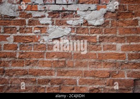 Weathered stained old brick wall background texture Stock Photo