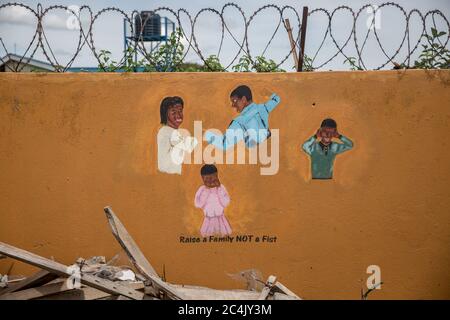 Paintings hanging on the walls at a shelter for domestic violence victims carry messages warning against family abuse. There are concerns about a rise in domestic violence during the coronavirus pandemic. Stock Photo