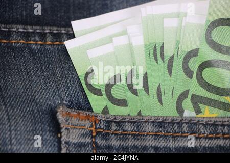 macro 100 euro banknote in jeans pocket. Personal save and spend money concept Stock Photo
