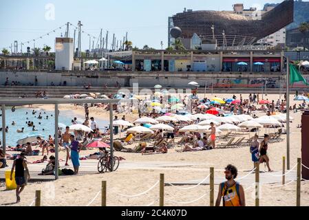 BARCELONA - JUNE 26, 2020: Platja de la Nova Icària beach with people in summer after COVID 19 on June 26, 2020 in Barcelona, Spain. Stock Photo