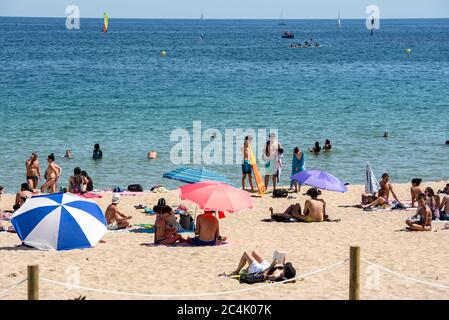 BARCELONA - JUNE 26, 2020: Platja de la Nova Icària beach with people in summer after COVID 19 on June 26, 2020 in Barcelona, Spain. Stock Photo