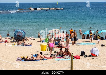 BARCELONA - JUNE 26, 2020: Platja de la Nova Icària beach with people in summer after COVID 19 on June 26, 2020 in Barcelona, Spain. Stock Photo