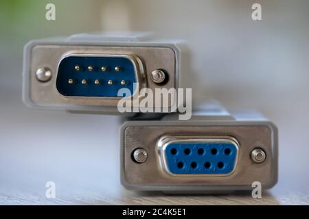 Close-up of a RS-232 serial port. Female to male extension cord on a wooden table. Stock Photo