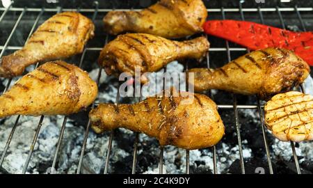 juicy golden grilled chicken legs on the grill, barbecue, coals Stock Photo