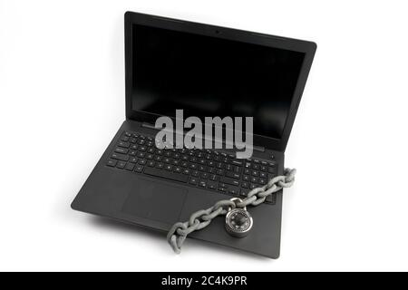 an open notebook computer with a chain and combination lock wrapped around the keyboard isolated on white Stock Photo