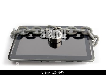 a tablet computer pad with a chain and lock wrapped around it isolated on white Stock Photo