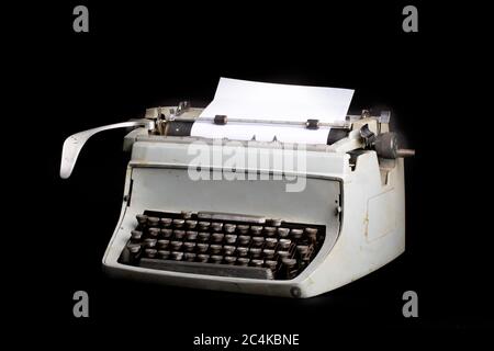a grungy old reporter's manual typewriter isolated on black Stock Photo