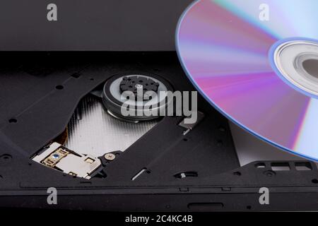 closeup of an open computer DVD CD drive with a re-writable DVD disk Stock Photo