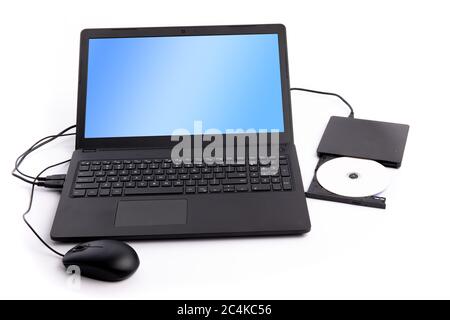 a notebook computer with an external DVD disk reader attached isolated on white Stock Photo