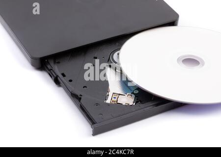 closeup of an open external computer DVD CD drive with a white DVD disk ready to insert Stock Photo