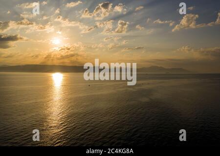 Sunrise with fluffy clouds over Mediterranean Sea Stock Photo