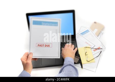 a man's hand on a computer keyboard with selective focus on the words past due on credit card statements isolated on white Stock Photo