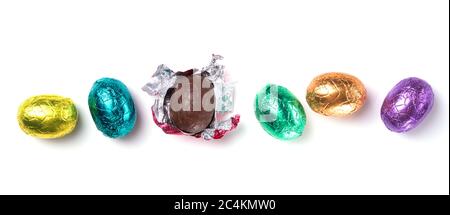 Chocolate easter eggs wrapped in multi colored foil isolated on white background Stock Photo