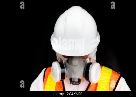 a person in a haz mat suit wearing an industrial dust and chemical mask respirator and safety goggles Stock Photo