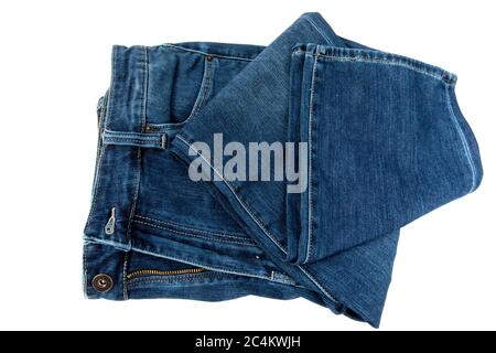 a pair of loosely folded denim blue jeans isolated on white Stock Photo