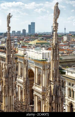 Milan Cathedral spires overlooking the Galleria Vittorio Emanuele II, Milan, Italy. Scenery of luxury Gothic roof with statues. Main church of Milan o Stock Photo