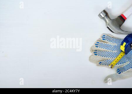 Construction attributes for the desktop on a wooden white background with top view and copy space Stock Photo