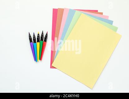 multicolored pastel construction paper fanned out with colorful ink markers  isolated on white Stock Photo - Alamy