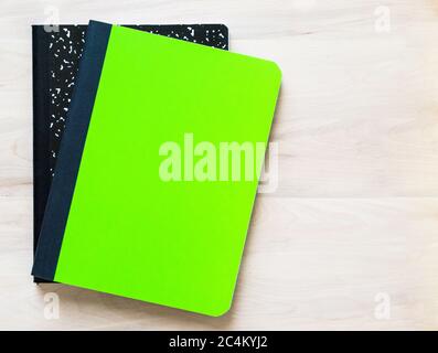 two notebooks with a blank cover for a personalized message, sitting on a wooden desk with copy space Stock Photo