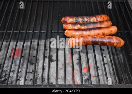 Grilled hot dog sausages. Beef or pork trimmings cut or ground into small pieces Stainless steel choppers blend meat spices ice chips into an emulsion Stock Photo