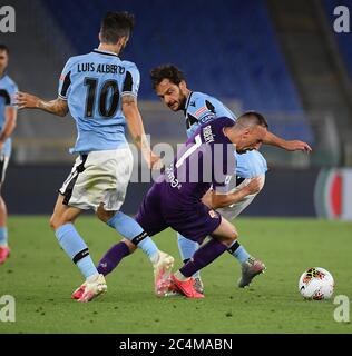 Rome. 28th June, 2020. Fiorentina's Frank Henry Pierre Ribery (C) vies with Lazio's Luis Alberto (L) and Marco Parolo during a Serie A football match between Lazio and Fiorentina in Rome, Italy, June 27, 2020. Credit: Xinhua/Alamy Live News Stock Photo