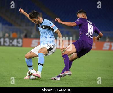 Rome. 28th June, 2020. Fiorentina's Rachid Ghezzal (R) vies with Lazio's Luis Alberto during a Serie A football match between Lazio and Fiorentina in Rome, Italy, June 27, 2020. Credit: Xinhua/Alamy Live News Stock Photo