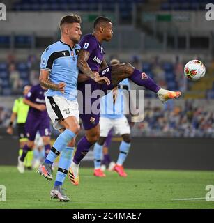 Rome. 28th June, 2020. Fiorentina's Igor Julio (R) vies with Lazio's Sergej Milinkovic-Savic during a Serie A football match between Lazio and Fiorentina in Rome, Italy, June 27, 2020. Credit: Xinhua/Alamy Live News Stock Photo