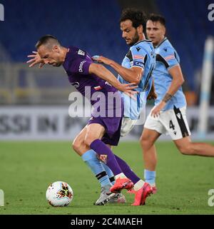 Rome. 28th June, 2020. Fiorentina's Frank Henry Pierre Ribery (L) vies with Lazio's Marco Parolo during a Serie A football match between Lazio and Fiorentina in Rome, Italy, June 27, 2020. Credit: Xinhua/Alamy Live News Stock Photo