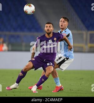 Rome. 28th June, 2020. Fiorentina's Patrick Cutrone (L) vies with Lazio's Patricio Gabarron Gil during a Serie A football match in Rome, Italy, June 27, 2020. Credit: Xinhua/Alamy Live News Stock Photo