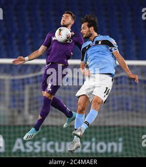 Rome. 28th June, 2020. Fiorentina's Gaetano Castrovilli (L) vies with Lazio's Marco Parolo during a Serie A football match between Lazio and Fiorentina in Rome, Italy, June 27, 2020. Credit: Xinhua/Alamy Live News Stock Photo