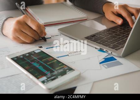 Businessman accountant or financial expert analyze business report graph and finance chart at corporate office. Concept of finance economy, banking bu Stock Photo