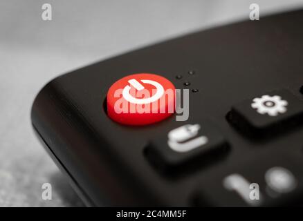 https://l450v.alamy.com/450v/2c4mm5f/closeup-of-the-red-turn-off-button-on-a-remote-control-under-the-lights-2c4mm5f.jpg