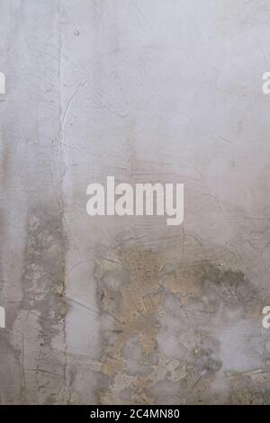 Old grunge texture white cement wall background, with little brown stain and wooden rectangular partition on the left hand side Stock Photo