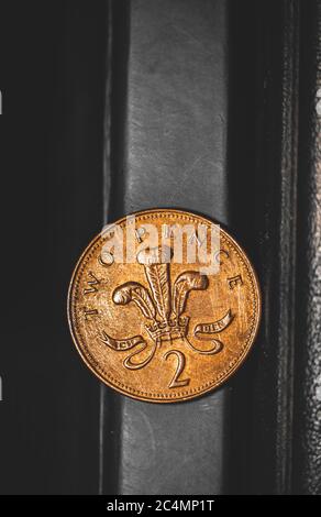 British coin 2 pence (2001) isolated on vintage black background with space for copy text. Front side of two pence coin. England coins collectors worl Stock Photo