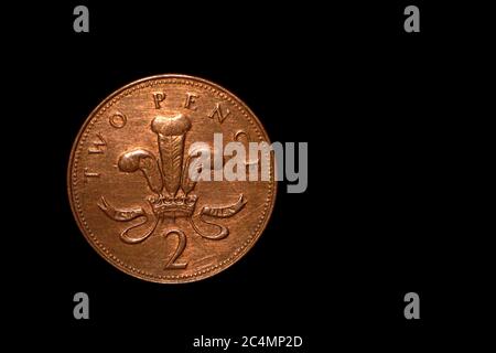 British coin 2 pence (2001) isolated on black background with space for copy text. Front side of two pence coin. England coins collectors world wide. Stock Photo