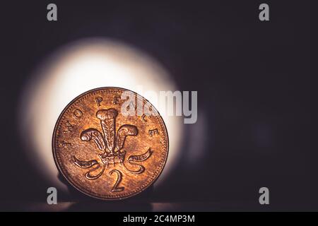 British coin 2 pence (2001) isolated on vintage dark and lighting background with space for copy text. Front side of two pence coin. England coins col Stock Photo