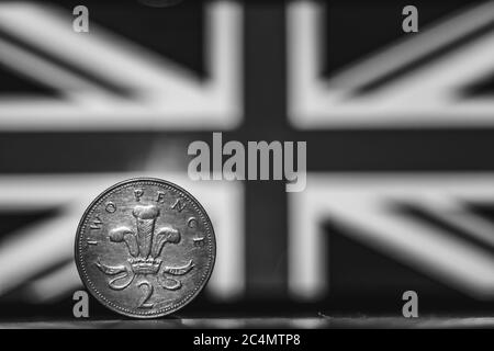 British coin 2 pence (2001) monochrome isolated on (UK) United kingdom flag background with space for copy text. Front side of two pence coin. England Stock Photo