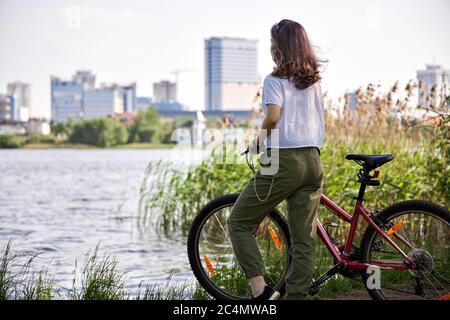 Urban biking teenage girl, bike in city. Active lifestyle.