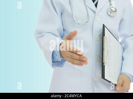 Doctor giving him hand for handshake to patient on a blue background. Concept of congrats, visit, encourage. Stock Photo