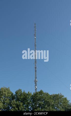 Broadcasting and Telecommunications Mast with a Bright Blue Sky Background by the M4 Motorway at Membury Services in Rural Berkshire, England, UK Stock Photo