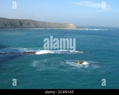 High angle shot of Globigerina Limestone white cliffs near the sea in Xrobb l-Ghagin, Malta Stock Photo