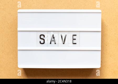 Lightbox with word save on wood background Stock Photo