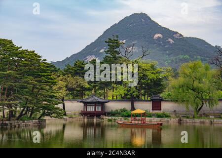 Small wooden boat on the pond near the Gyeongbokgung Palace in South Korea Stock Photo