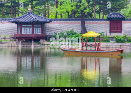 Small wooden boat on the pond near the Gyeongbokgung Palace in South Korea Stock Photo